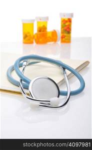 Stethoscope file folder and pill bottles with reflections