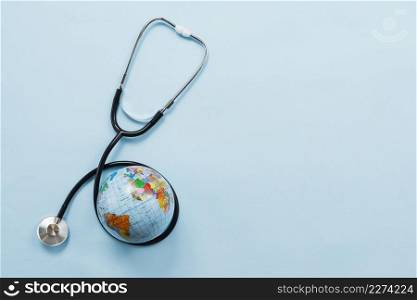 stethoscope hugging earth blue background. Resolution and high quality beautiful photo. stethoscope hugging earth blue background. High quality beautiful photo concept