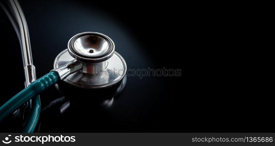 Stethoscope on a glass table, dark background, The concept of medicine and medical treatment