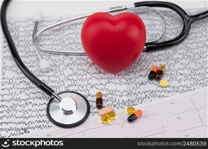 Stethoscope on electrocardiogram, and toy heart. Concept healthcare. Cardiology - care of the heart. cardiology, heart care