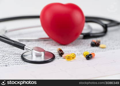 Stethoscope on electrocardiogram, and toy heart. Concept healthcare. Cardiology - care of the heart. cardiology, heart care