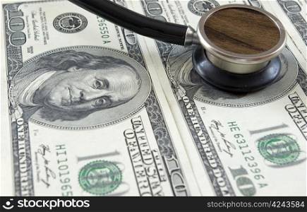Stethoscope on money background of dollars