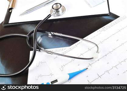 stethoscope on printout of heart monitor -blue tint