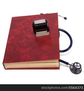 stethoscope on red book isolated on white background