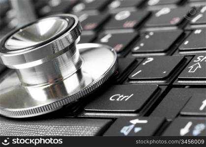 stethoscope on the laptop keyboard, close-up view