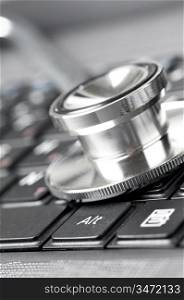stethoscope on the laptop keyboard, close-up view