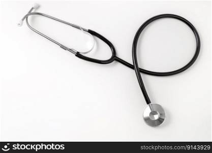 Stethoscope on white background, top view. Medical tool. Copy space, free space for text. Stethoscope on white background, top view. Medical tool. Copy space, free space for text.