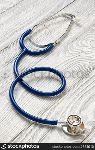 Stethoscope on white wooden background