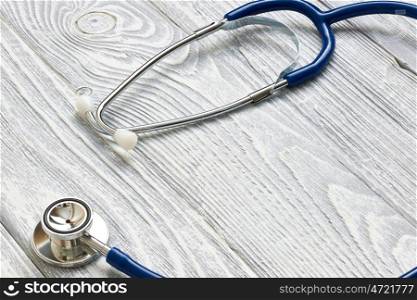 Stethoscope on white wooden background