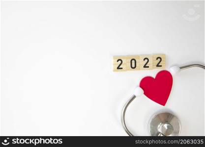 Stethoscope with 2022 isolated on white background. Happy New Year for health care and medical banner calendar cover. Creative idea for new trend in medicine treatment and diagnosis concept.copy space space for text. Stethoscope with 2022 isolated on white background. Happy New Year for health care and medical banner calendar cover. Creative idea for new trend in medicine treatment and diagnosis concept.copy space