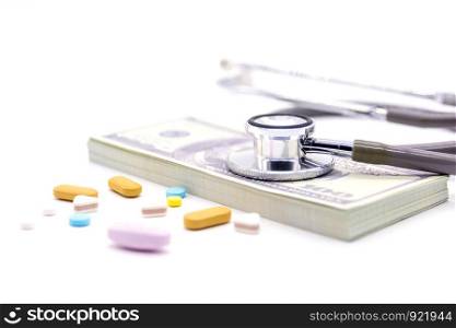 Stethoscope with dollar bank and medicine capsules on white background. healthy lifestyle with business finance concept
