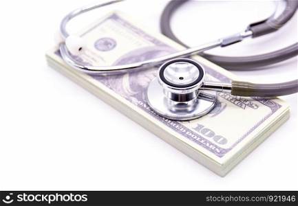 Stethoscope with dollar bank and medicine capsules on white background. healthy lifestyle with business finance concept