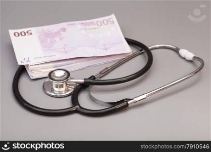 stethoscope with euro banknotes isolated on gray