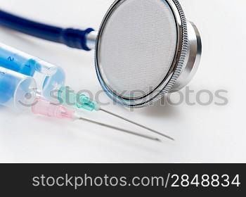 Stethoscope with injections close-up medical equipment white background