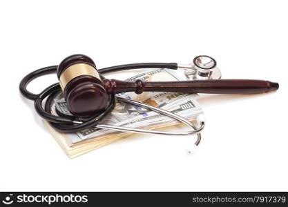 Stethoscope with judge gavel and dollar banknotes on white background