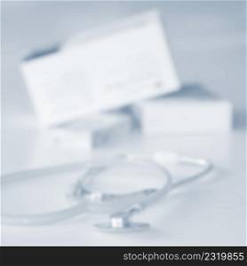 Stethoscope with medication on the table. Concept for health and medicine. Hospital background.