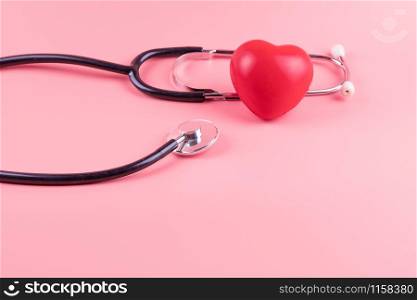Stethoscope with Red heart shape on pink background. Healthcare, life Insurance, World Heart Day amd cancer concept