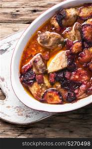 stew meat in plum sauce. meat stew in sauce of autumn plums on a retro background
