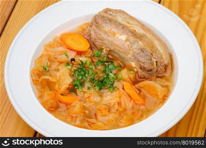 Stewed cabbage and other vegetables with pork meat. Stewed cabbage with pork meat