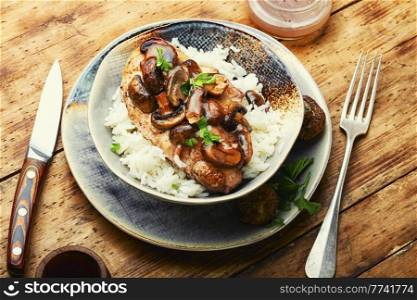 Stewed chicken breast with marsala mushroom gravy and rice.. Chicken with mushroom sauce.