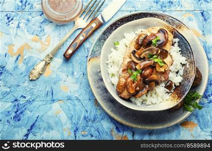 Stewed chicken breast with marsala mushroom gravy and rice. Space for text. Chicken with mushroom sauce.