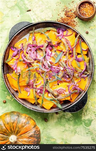 Stewed pumpkin with red onion and vigna.Traditional autumn dishes from pumpkin. Baked pumpkin with vegetables
