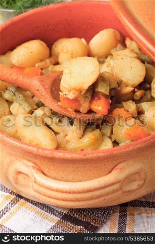 Stewed vegetables in pottery on table