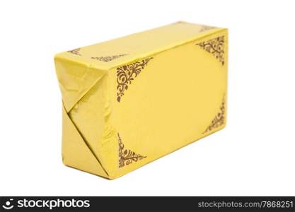 Stick of wrapped butter on white background