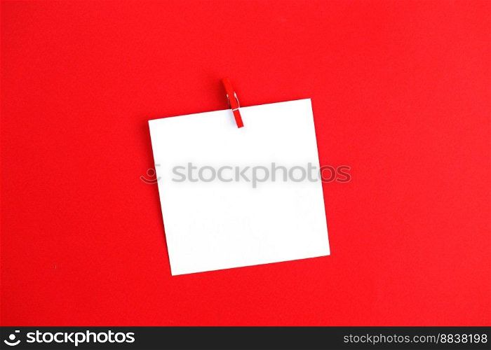 sticker with empty mockup for your text hanging on the pin on red background. Copy space for text.. sticker with empty mockup for your text hanging on the pin on red background. Copy space for text
