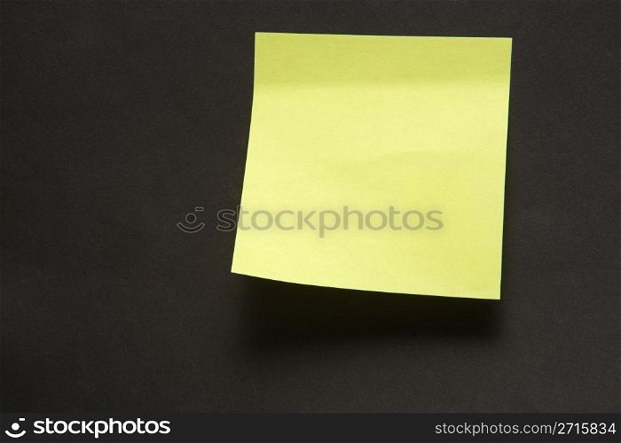 Sticky note attached on a black background