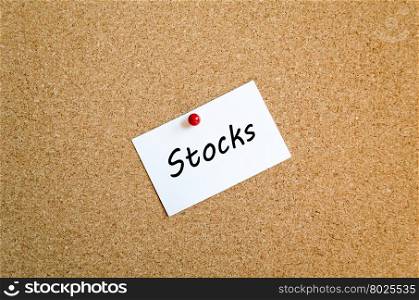 Sticky Note On Cork Board Background And Stocks Text Concept