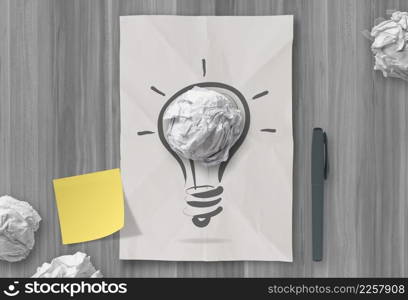 sticky note with another idea light bulb on crumpled paper as creative concept