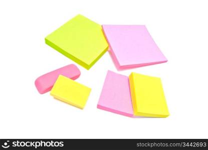 sticky notes and erasers close-up on white background