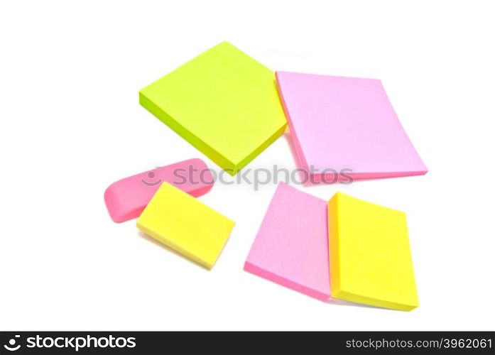 sticky notes and erasers on white background
