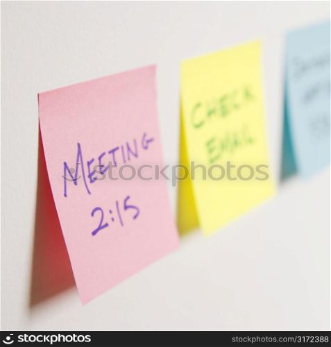 Sticky notes of to do list on wall.