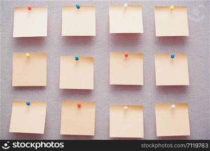 Sticky notes on a bulletin board. Close-up view