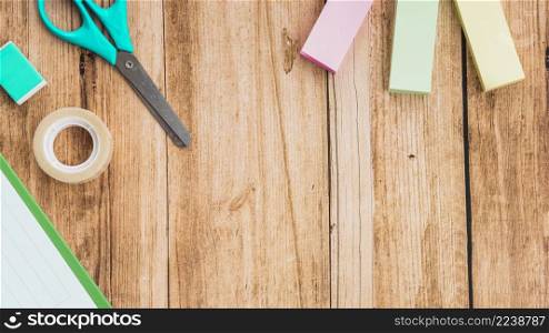 sticky notes scissor tape eraser wooden table
