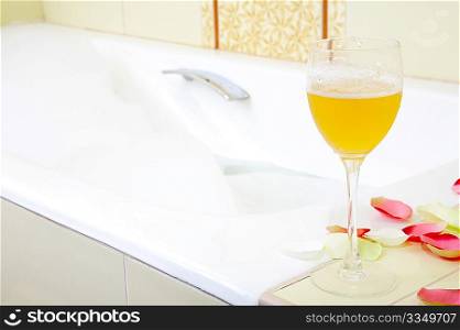 Still-life a glass with a drink against a bath with foam