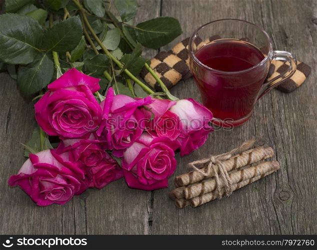 still life bouquet of roses, circle of red drink and two groups of cookies, subject beautiful flowers and drinks, greeting card