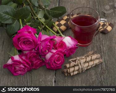 still life bouquet of roses, circle of red drink and two groups of cookies, subject beautiful flowers and drinks, greeting card