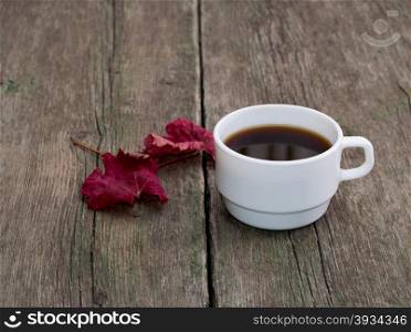 still life, coffee and brightly red leaf on a wooden table, fall, a subject drinks