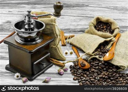 Still life coffee beans, coffee grinder and cinnamon.