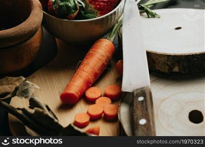 Still life concept shot of spanish cooking with a carrot and different accessories for the kitchen