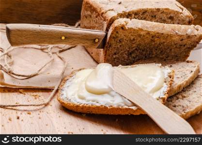 Still life fresh whole wheat bread with butter and honey rustic wooden table background