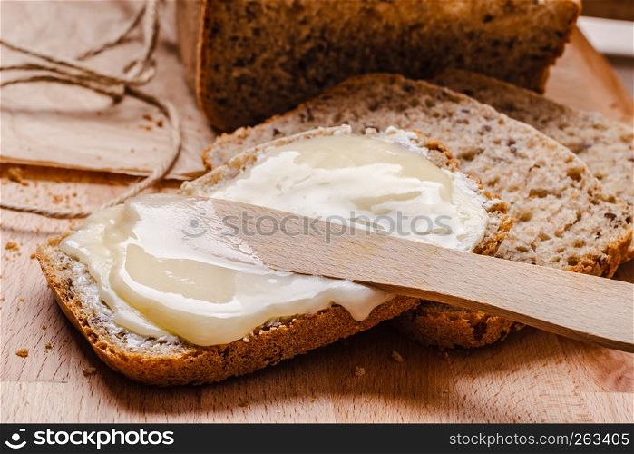 Still life fresh whole wheat bread with butter and honey rustic wooden table background