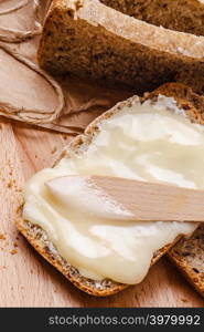 Still life fresh whole wheat bread with butter and honey rustic wooden table background