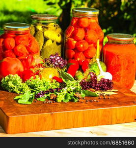 still life from marinated and fresh vegetables on the garden