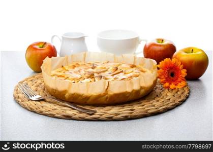 still life of apple pie, apple Gerbera milk jug and a cup
