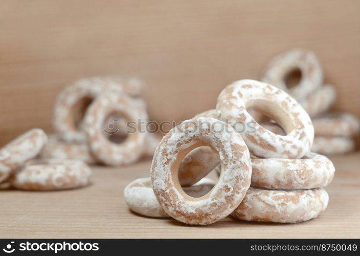 Still life of donut glaze on a wooden surface. Glazed bagels are a small bunch on a wooden table. Flour sweets to the Tea Party. Glazed bagels on wooden table