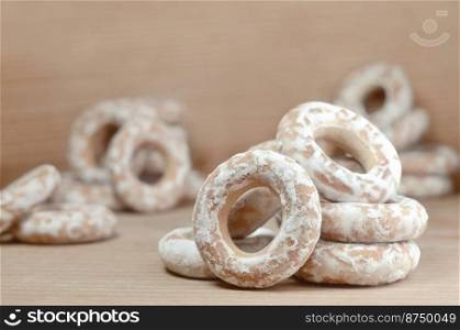 Still life of donut glaze on a wooden surface. Glazed bagels are a small bunch on a wooden table. Flour sweets to the Tea Party. Glazed bagels on wooden table